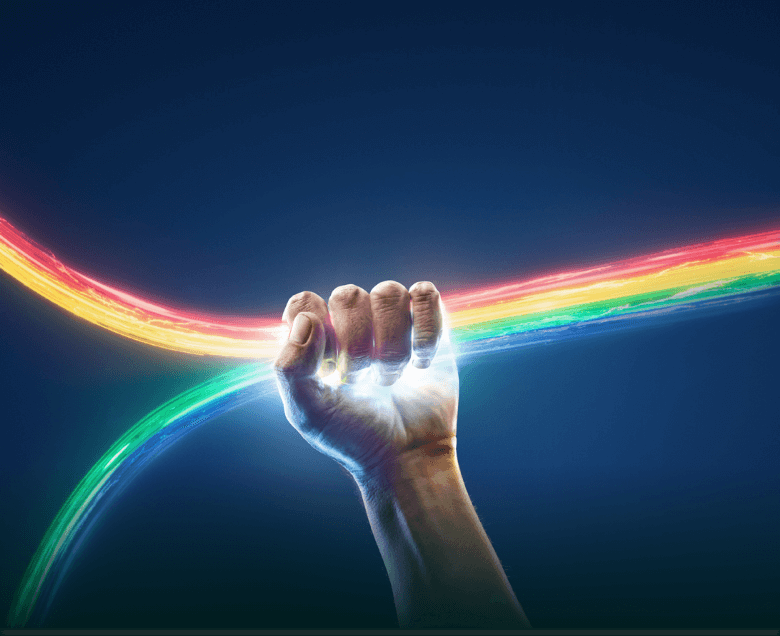 Hand tightly holding rainbow