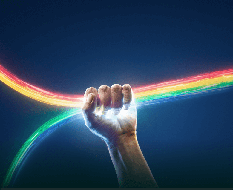 Hand tightly holding rainbow Hand tightly holding rainbow