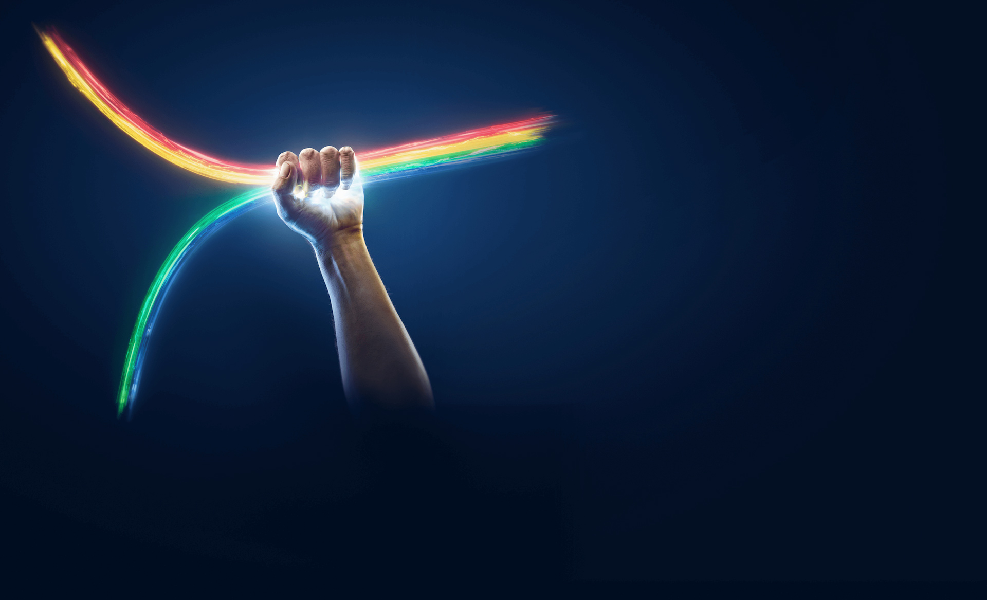 Hand tightly holding rainbow Hand tightly holding rainbow